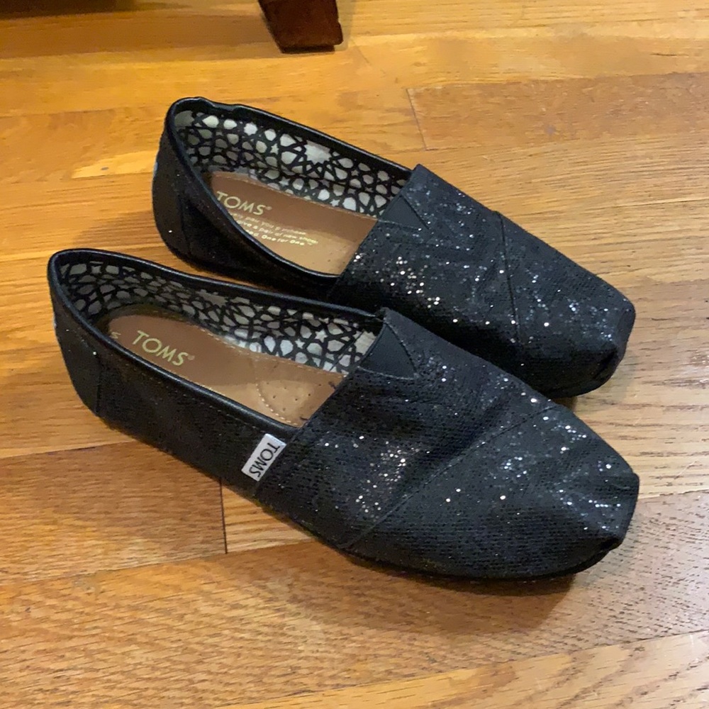 Tom’s black glitter flats